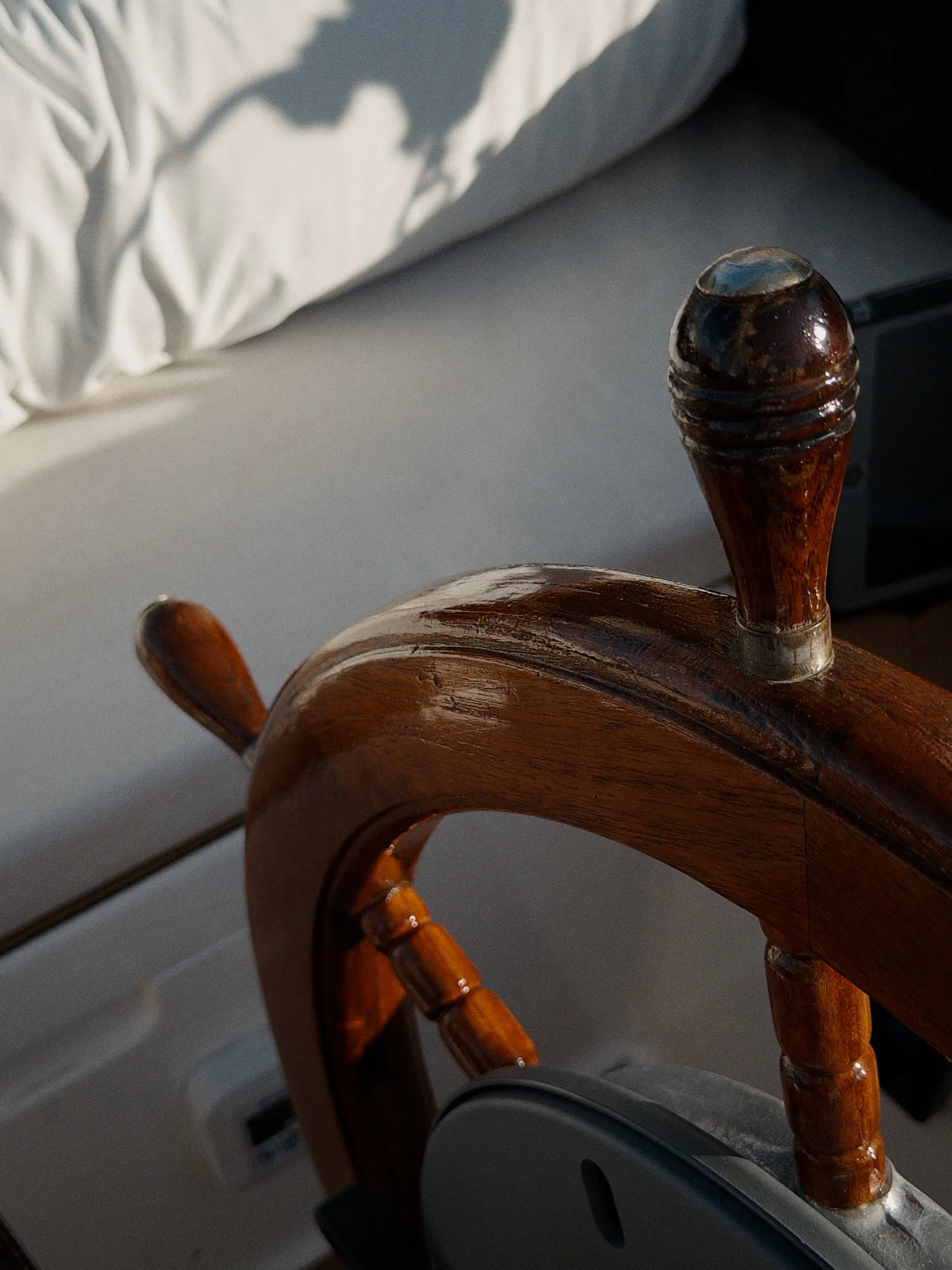 Detail of the varnished wooden ship’s wheel